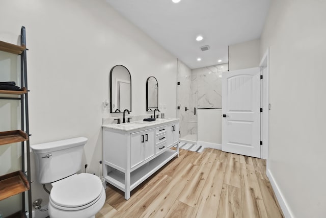 7450 Sears Rd, Horton, MI 49246 - bathroom featuring toilet, wood finished floors, visible vents, a sink, and a marble finish shower