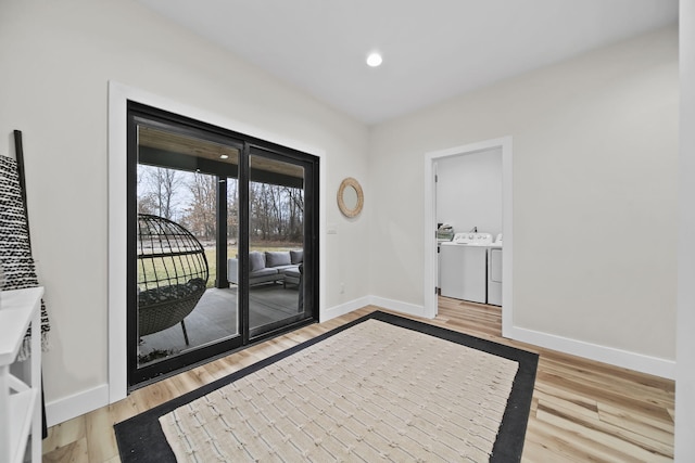 7450 Sears Rd, Horton, MI 49246 - interior space featuring washer and clothes dryer, recessed lighting, light wood-style flooring, and baseboards