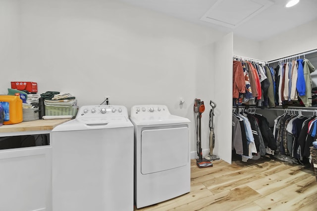 7450 Sears Rd, Horton, MI 49246 - clothes washing area with laundry area, light wood-style flooring, attic access, and washer and dryer