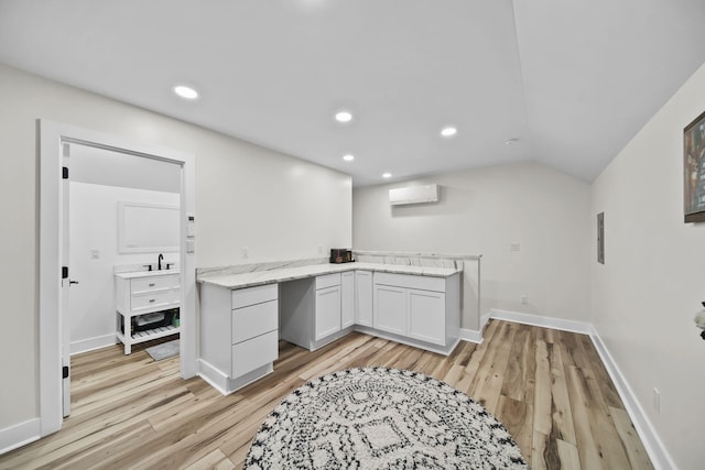 7450 Sears Rd, Horton, MI 49246 - kitchen with an AC wall unit, light wood-type flooring, a sink, and recessed lighting