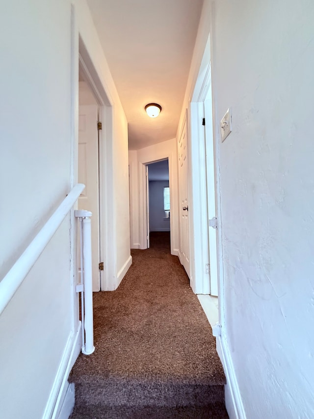 hall with carpet and baseboards