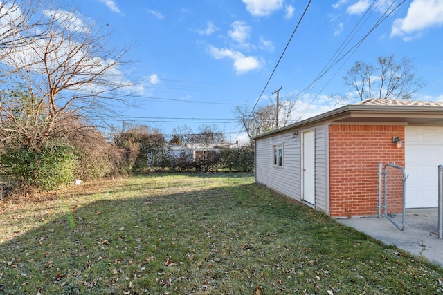 view of yard with a garage and an outdoor structure