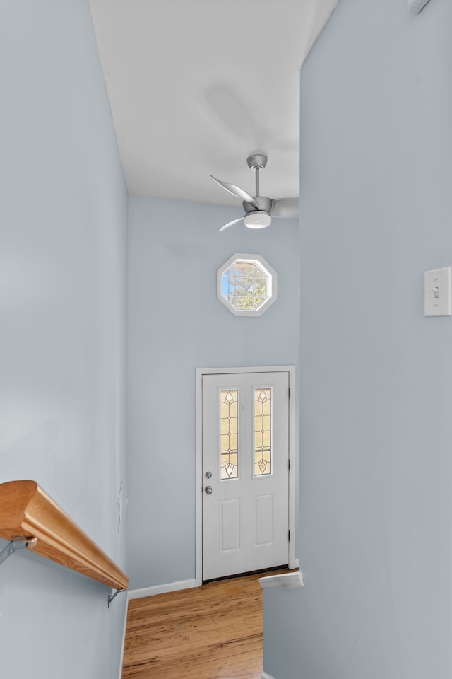 foyer featuring baseboards, a ceiling fan, and wood finished floors