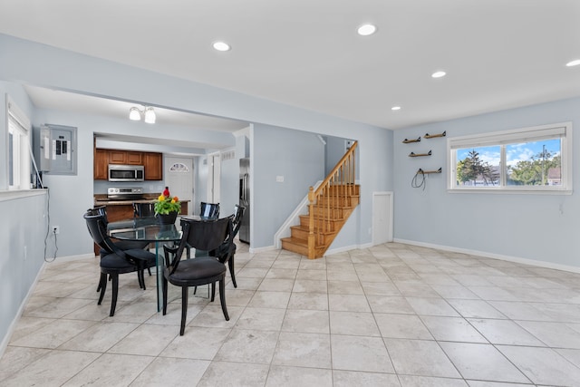 dining room with baseboards, stairway, and recessed lighting