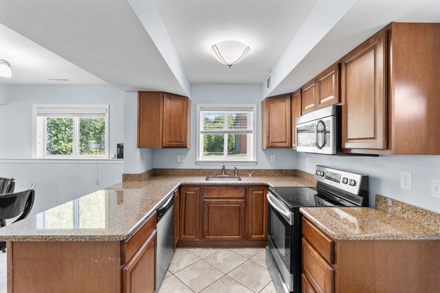 34134 Dequindre Rd, Sterling Heights, MI 48310 - kitchen featuring stainless steel appliances, a sink, brown cabinetry, and healthy amount of natural light