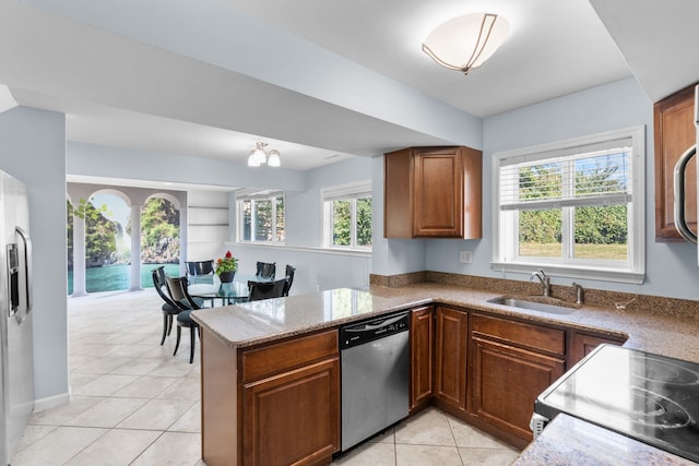 34134 Dequindre Rd, Sterling Heights, MI 48310 - kitchen with appliances with stainless steel finishes, a sink, light tile patterned floors, light stone countertops, and a peninsula