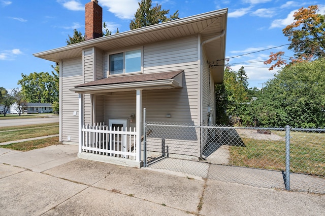 34134 Dequindre Rd, Sterling Heights, MI 48310 - view of front facade with a fenced front yard, a chimney, and a gate