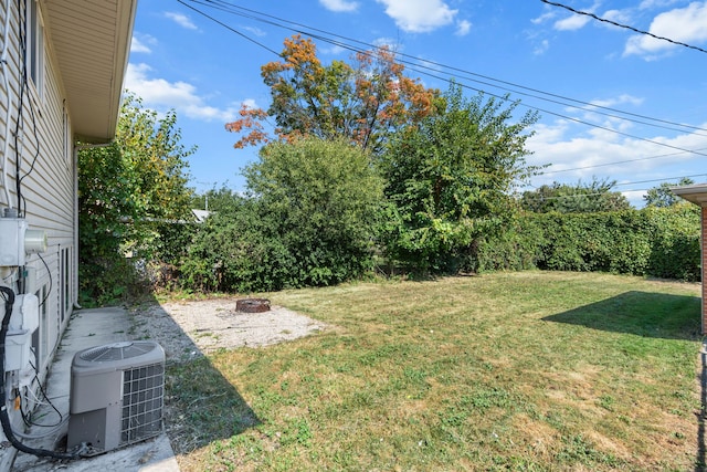 34134 Dequindre Rd, Sterling Heights, MI 48310 - view of grassy yard with cooling unit and an outdoor fire pit