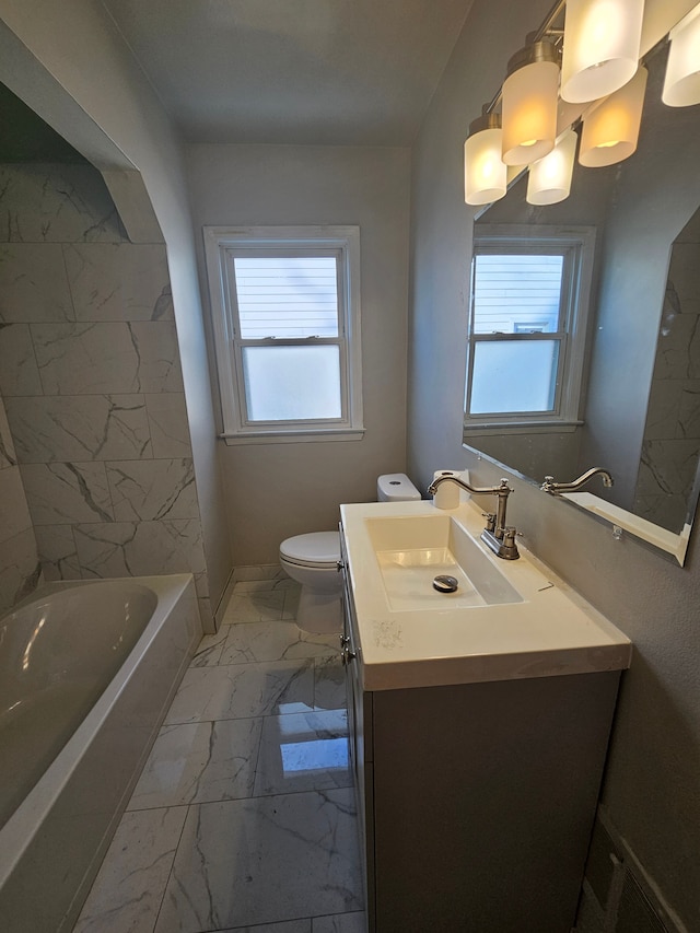 bathroom with marble finish floor, vanity, toilet, and a bath