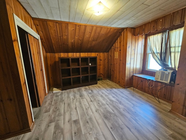 additional living space featuring lofted ceiling, wooden ceiling, cooling unit, wood walls, and wood finished floors