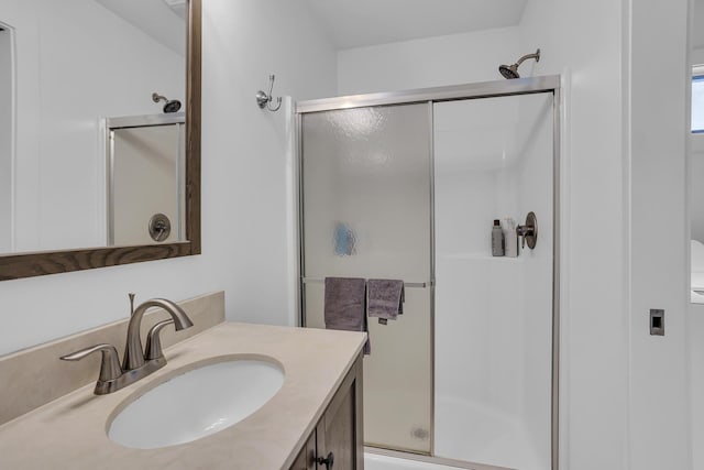 bathroom featuring a stall shower and vanity