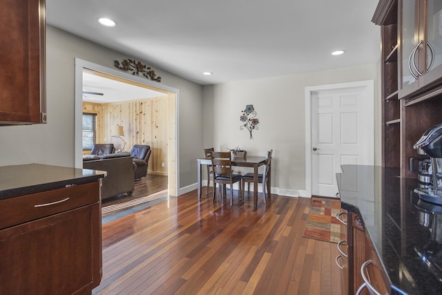 dining space with recessed lighting, dark wood-style flooring, and baseboards