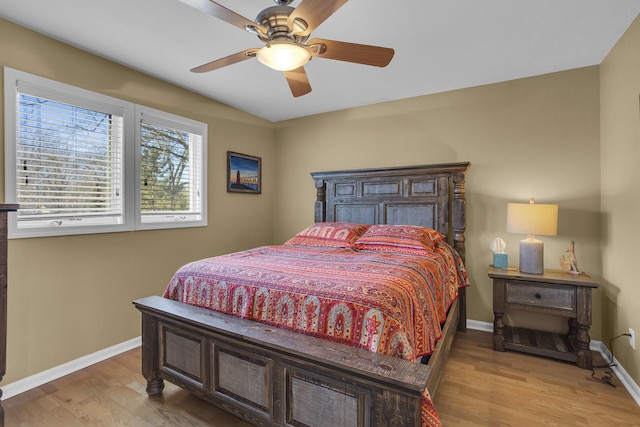 bedroom featuring baseboards, ceiling fan, and light wood finished floors