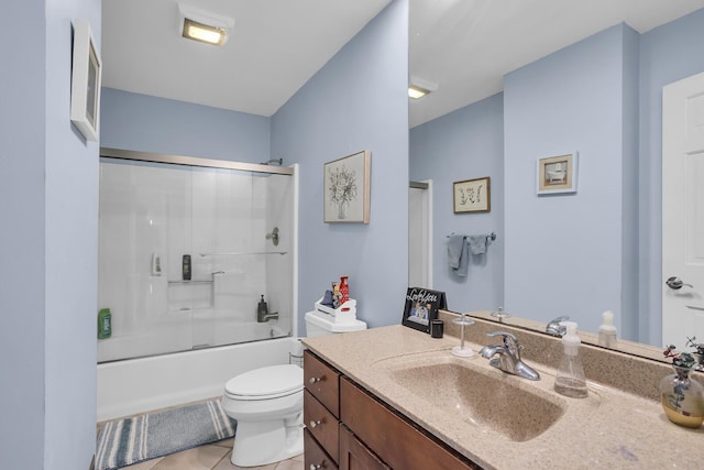 bathroom with bath / shower combo with glass door, vanity, toilet, and tile patterned floors