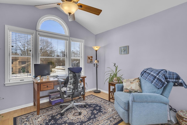 office space featuring vaulted ceiling, ceiling fan, wood finished floors, and baseboards