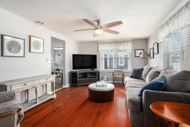 living room featuring a ceiling fan, baseboards, visible vents, and hardwood / wood-style floors