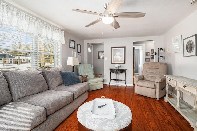 living area featuring ceiling fan, baseboards, and wood finished floors