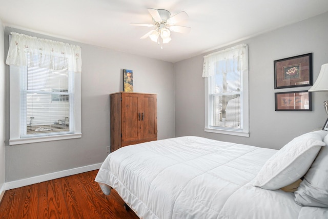 bedroom with a ceiling fan, baseboards, and wood finished floors