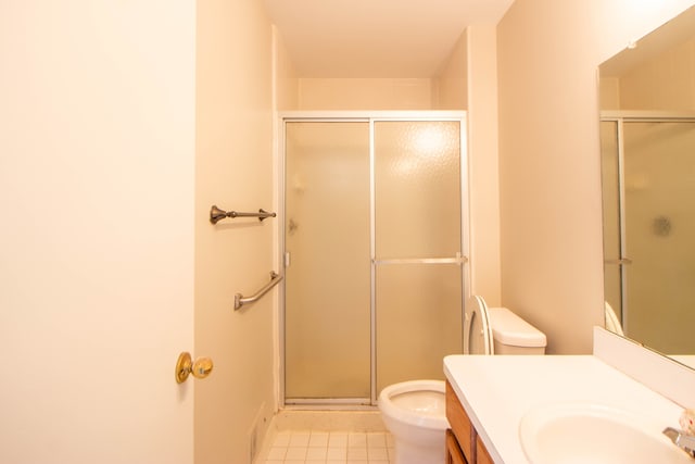 full bathroom featuring toilet, a stall shower, vanity, and tile patterned floors