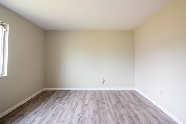 unfurnished room featuring light wood-style flooring and baseboards