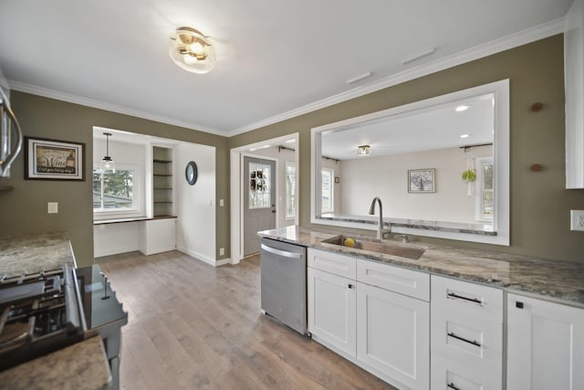 kitchen with dishwasher, ornamental molding, light wood-type flooring, white cabinetry, and a sink