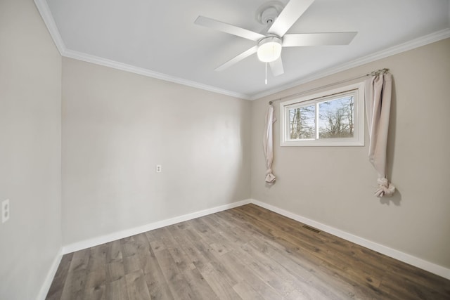 empty room featuring visible vents, baseboards, ceiling fan, ornamental molding, and wood finished floors