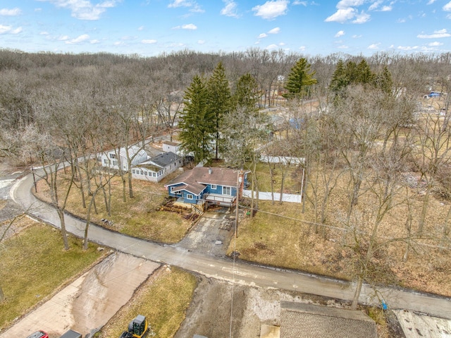 birds eye view of property with a wooded view