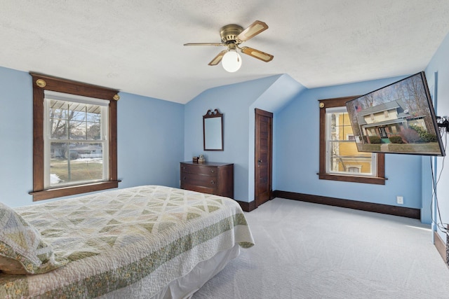 carpeted bedroom featuring a textured ceiling, ceiling fan, vaulted ceiling, and baseboards