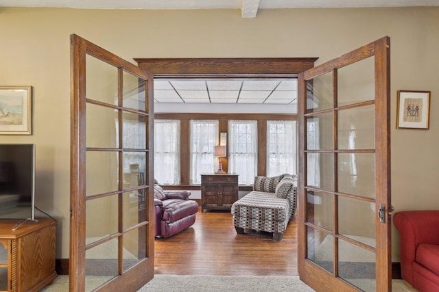 sitting room with french doors and wood finished floors