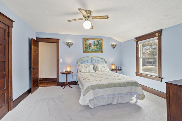 carpeted bedroom with lofted ceiling, baseboards, and a textured ceiling