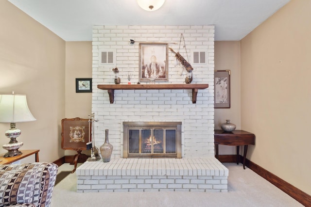 carpeted living area with a brick fireplace, visible vents, and baseboards