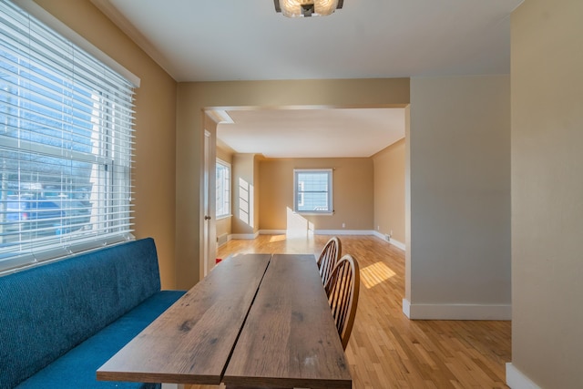 dining space with light wood-style floors and baseboards