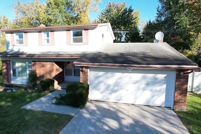 traditional-style house with a garage, driveway, brick siding, and a front lawn