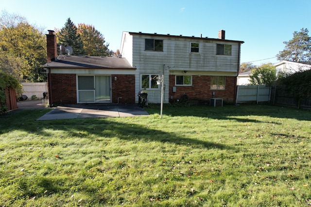 rear view of property with a patio area, a chimney, cooling unit, and brick siding