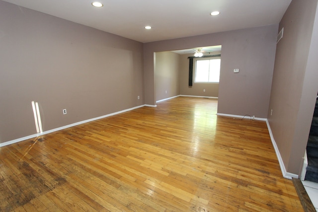 empty room featuring recessed lighting, light wood-style flooring, and baseboards