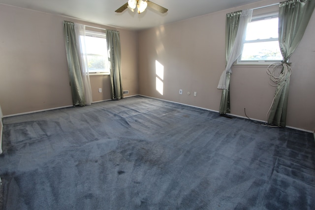 unfurnished room with carpet, a healthy amount of sunlight, and ceiling fan