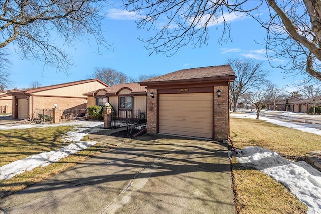 view of front of property featuring a garage, concrete driveway, and brick siding