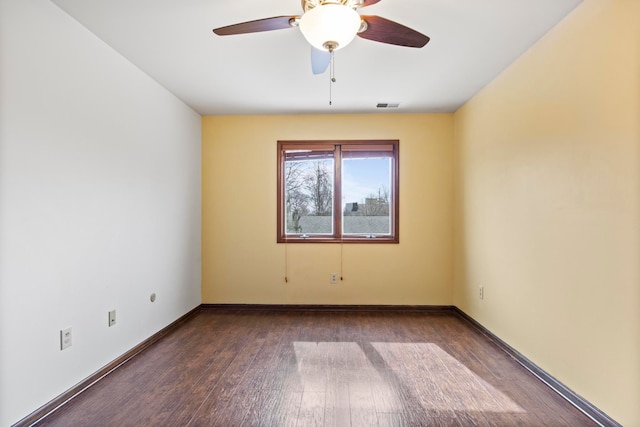 unfurnished room featuring visible vents, ceiling fan, hardwood / wood-style flooring, and baseboards