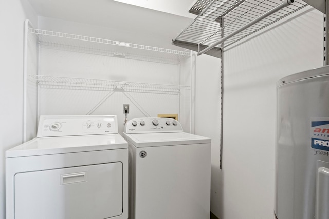 laundry room with water heater, laundry area, and washing machine and dryer