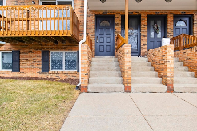 doorway to property featuring brick siding