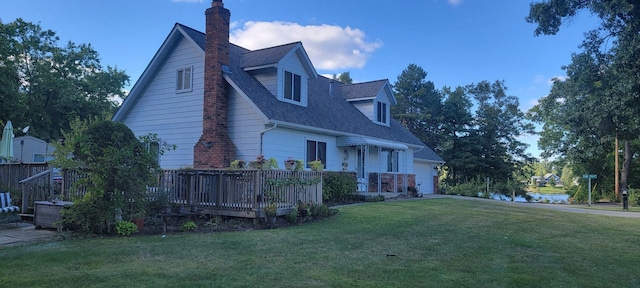 view of side of home with roof with shingles, a chimney, a lawn, an attached garage, and a wooden deck