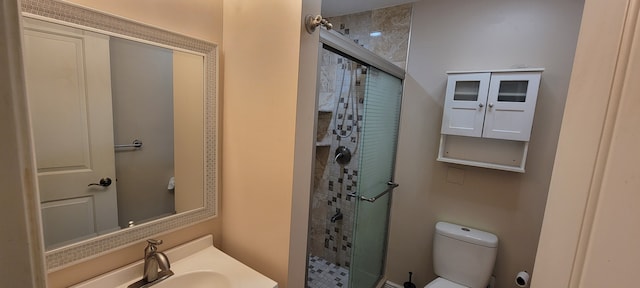 bathroom with a stall shower, a sink, and toilet