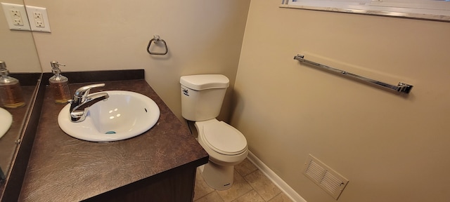 bathroom with baseboards, visible vents, vanity, and toilet