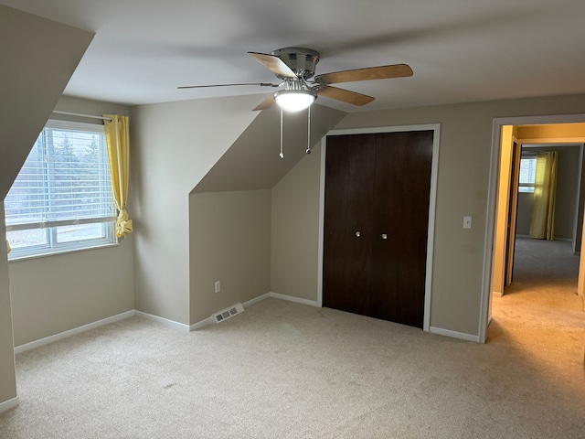 bonus room featuring ceiling fan, carpet, visible vents, and baseboards