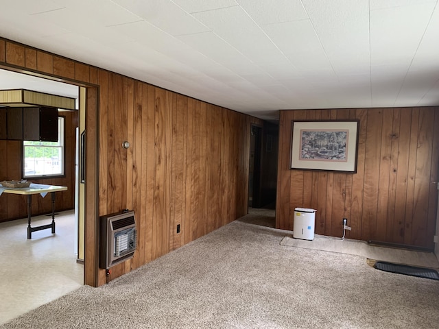 7004 Walnut Hill Rd, Manitou Beach, MI 49253 - unfurnished living room with heating unit, wood walls, and carpet