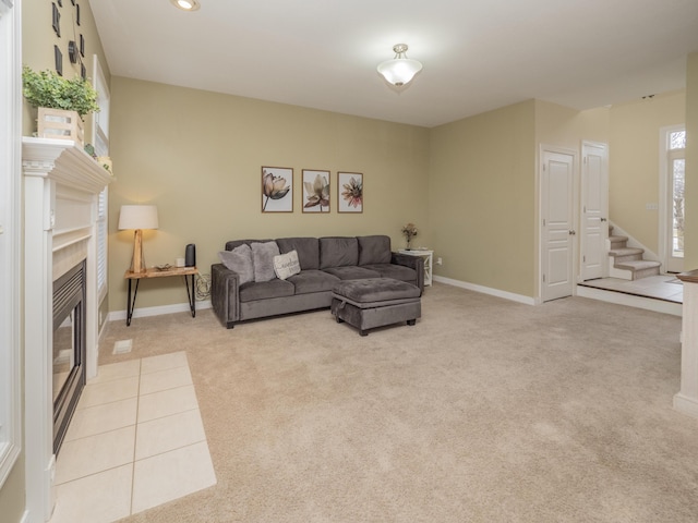 living room with baseboards, light colored carpet, stairs, a fireplace, and recessed lighting