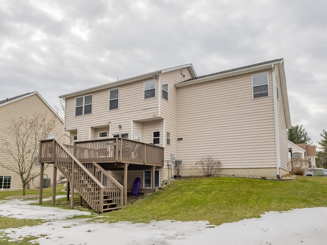 rear view of property with a yard, stairway, and a wooden deck