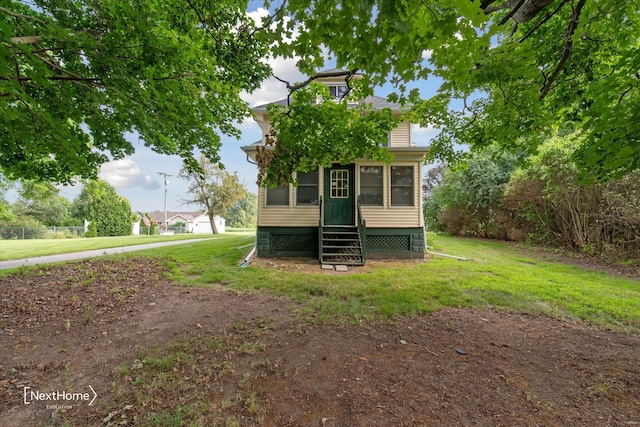 view of front of house with a sunroom and a front lawn