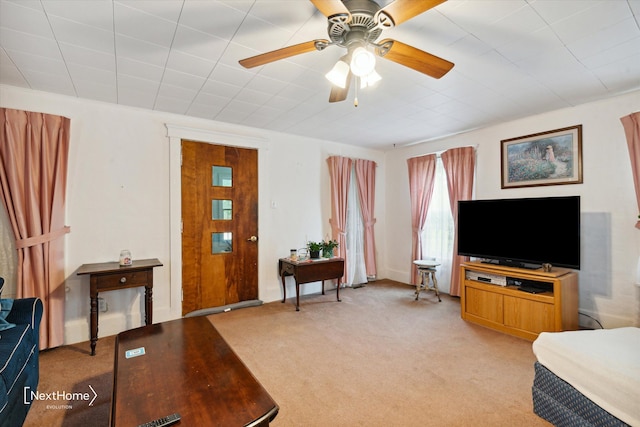 living room with a ceiling fan and light carpet