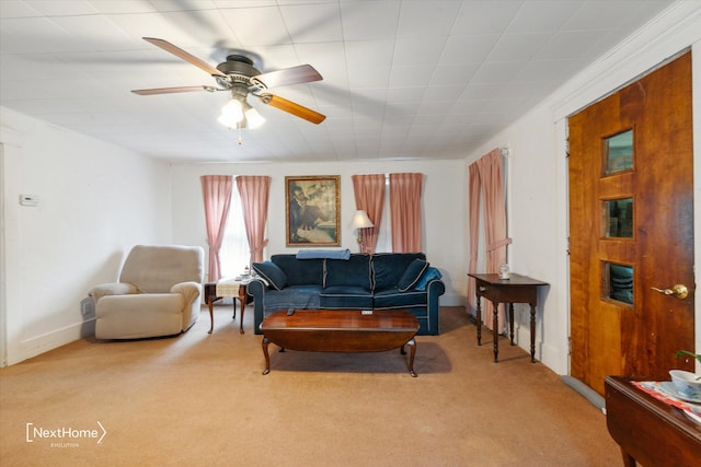 carpeted living area featuring a ceiling fan and baseboards